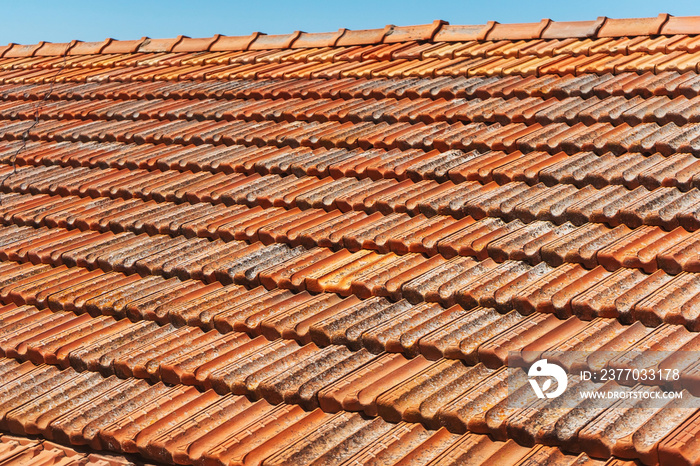 Old tiles on the roof of a house in cyprus. clay orange tiles. ecological roof