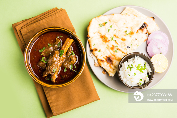 Mutton Masala Or Masala Gosht or indian lamb rogan josh with some seasoning, served with Naan or Roti, selective focus