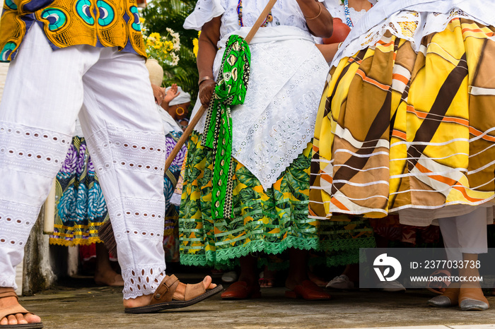 Lower part of candomble members dressed in traditional clothes for religious festival