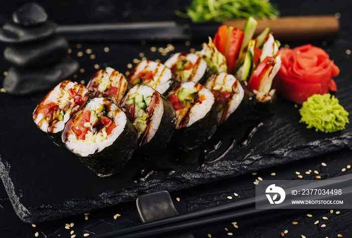 Vegetarian maki sushi rolls on black plate