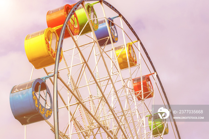 Ferris wheel with colorful cabs against the sky.