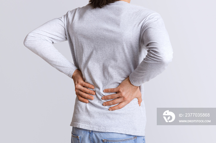 Renal colic and back pain. Man suffers from lower back pain