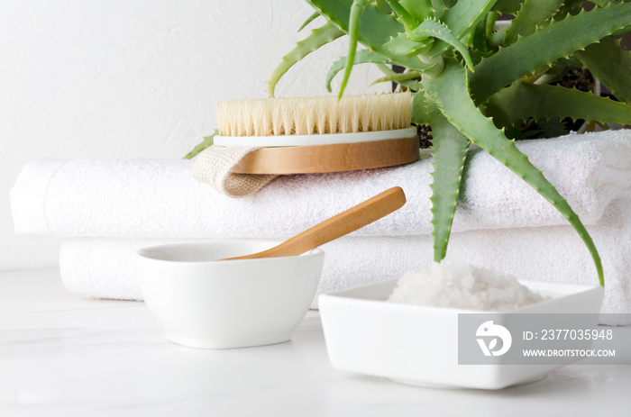 Closeup of salt and clay for bath.Towels and body brush preparing for taking care of body