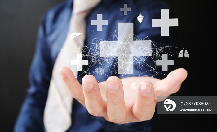 Businessman has virtual medical health care icons with medical and network connections in his hand. People’s understanding of health care is growing, as is the medical health and life insurance.