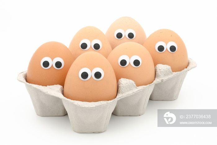 six eggs in a box with googly eyes on white background