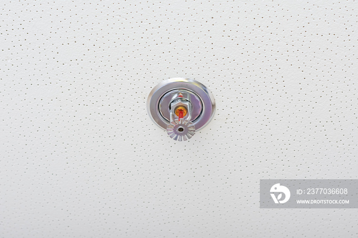 Fire fighting equipment, sprinkler on white ceiling background.