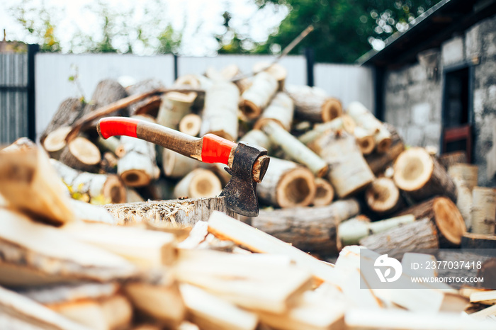 A sharp blade of an ax that sticks out in a wooden chock. rustic concept