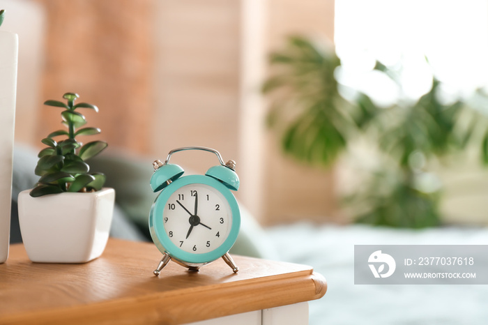 Alarm clock on table in bedroom