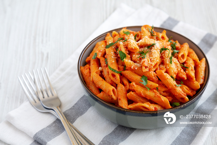 Homemade Penne Alla Vodka from Leftover Sauce with Cheese and Parsley, low angle view.