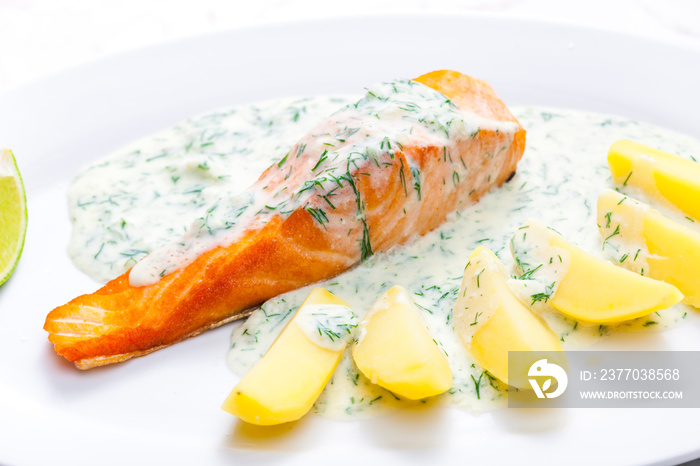 baked salmon with creamy dill sauce and potatoes