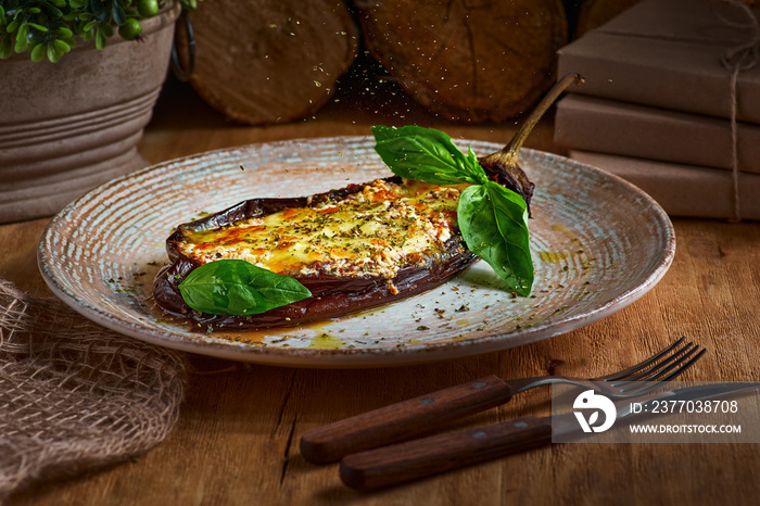 eggplant, meat stews, tomatoes, cheese, delicious Italian dish. On the wooden table