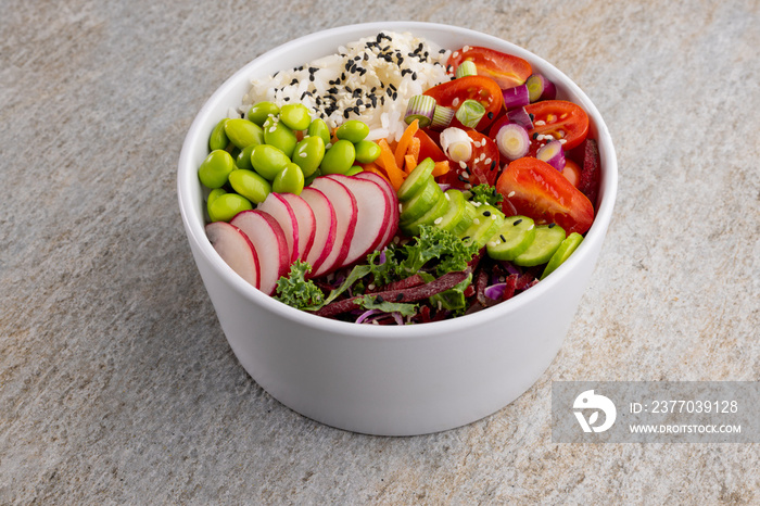 Overhead view of hawaiian poke bowl on grey background