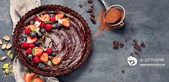 Delicious chocolate tart on gray background. Homemade desserts concept.