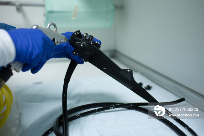 Nurse doctor preparing equipment for endoscopy inside emergency hospital room - Focus on tube set