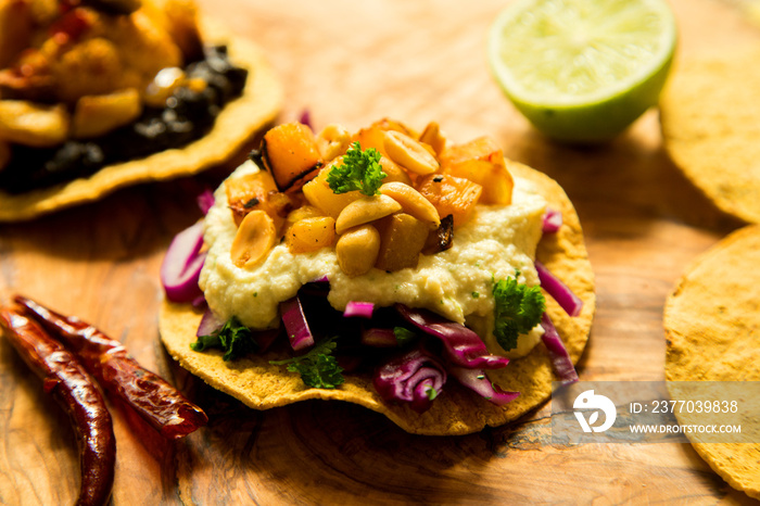 Tostada with hummus and vegetables. Tostada, name given to various dishes in Mexico that include a toasted tortilla as the main base of its preparation.