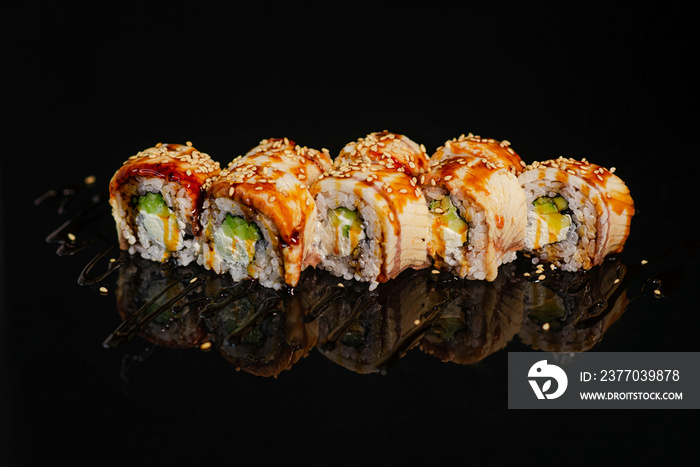 Sushi roll on black glossy background.