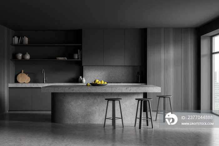 Grey kitchen interior with table and chairs near window on concrete floor