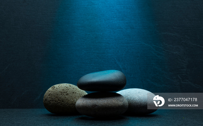 zen stones for podium stand pedestal platform background.grey and black oval stones on dark gray background for product presentation,background