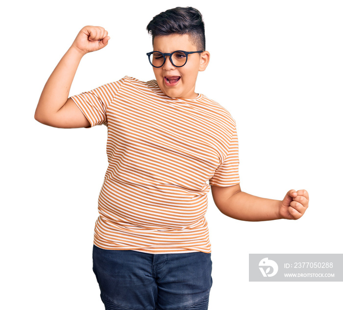 Little boy kid wearing casual clothes and glasses dancing happy and cheerful, smiling moving casual and confident listening to music