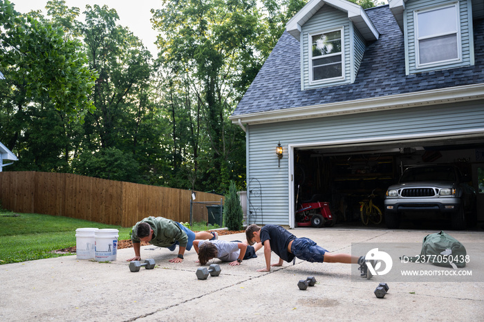 Air Force service member trains with his sons in a morning workout in preperation for a PT fitness test.