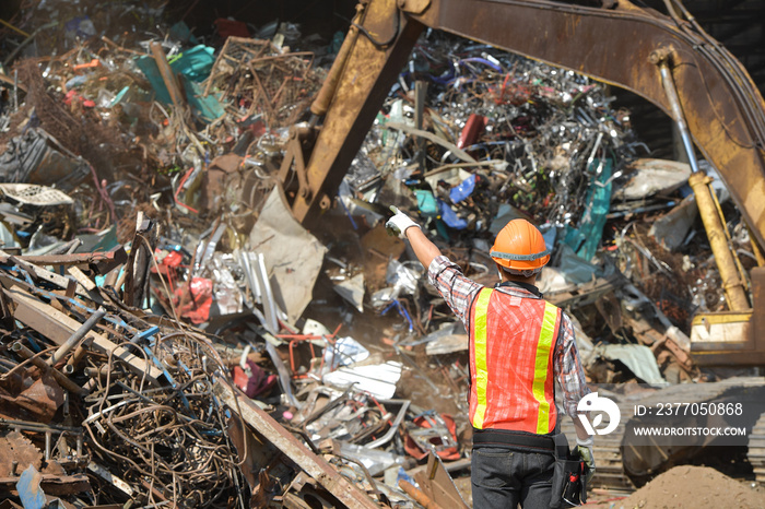 Portrait workers wearing biohazard suits and hardhats working at waste processing plant sorting inside factory