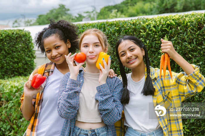 Smiling students Different ethnicities in farm vegetable. Teen age mix race happy and smile holding  vegetables fresh from farm