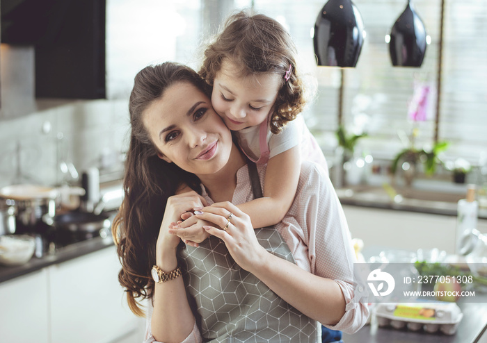 Portrait of a cute daughter hugging her mother