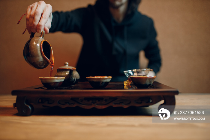 Chinese traditional puerh tea ceremony. Shepherd, chahay and gaiwan pour puehr tea