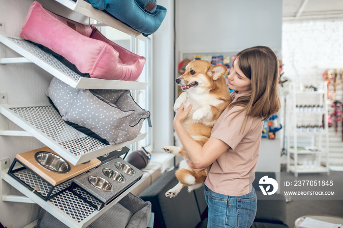 Pet owner choosing a pet bed in a pet shop