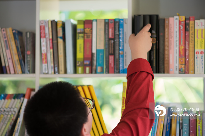 Students boy and girl in the library read books and ebook for education