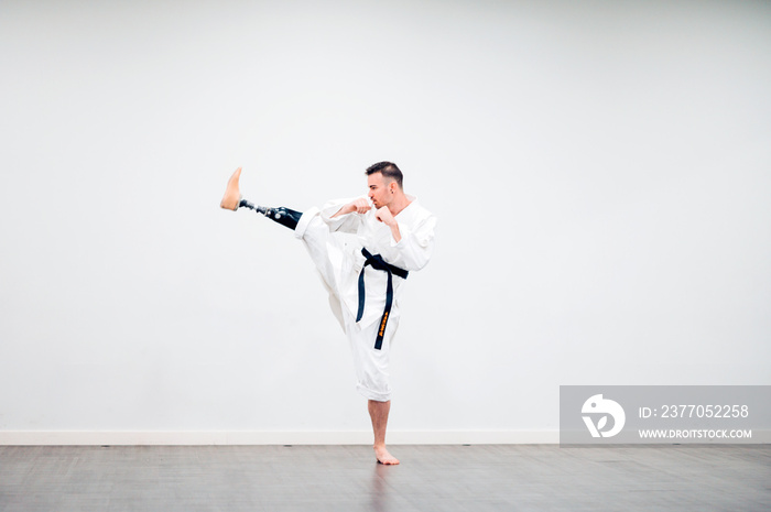 Man with prosthetic leg practicing karate