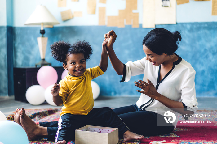 African american mother playing with adorable little african american girl at home.Love of black family concept