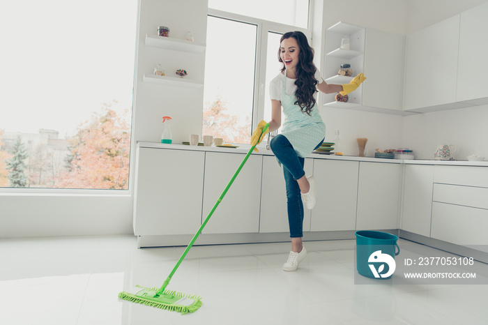 Full length body size side profile photo beautiful cheerful hardworking duties she her lady house love clean dancing singing wear jeans denim casual t-shirt covered cute apron bright light kitchen