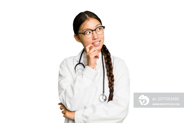 Young doctor asian woman isolated relaxed thinking about something looking at a copy space.