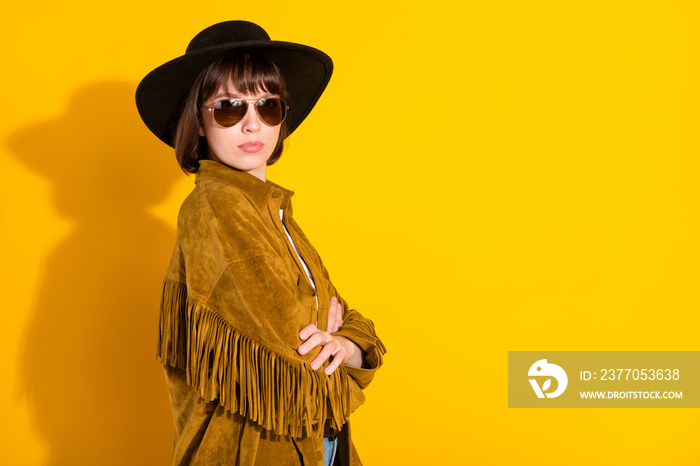 Photo of cool confident lady wear cowgirl outfit dark glasses headwear hands crossed empty space isolated yellow color background