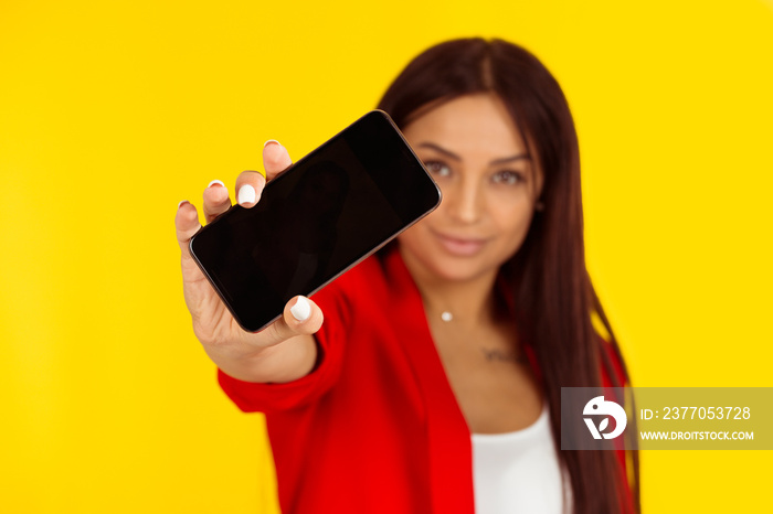 woman holding smart phone with a blank black screen