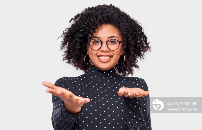 Confused African American young woman shrug shoulders, looks uncertain, confused with open hand palms, has doubts. Dark-skinned female can’t make choise. People emotions and feelings concept.