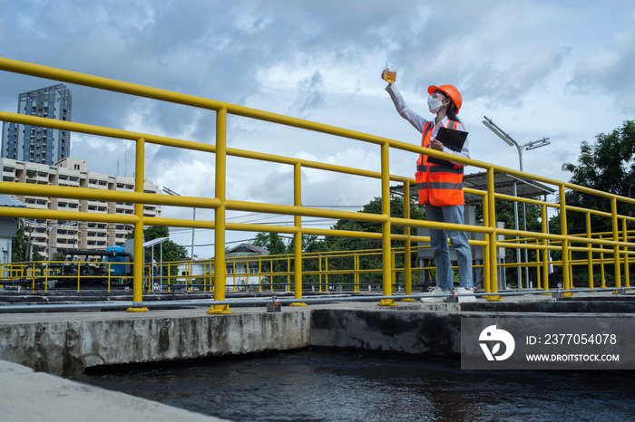 construction worker on site. Engineers controlling a quality of water ,aerated activated sludge tank at a waste water treatment plant.