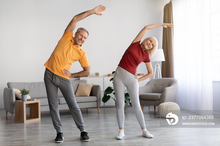 Positive mature couple having workout at home