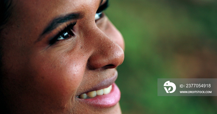 Contemplative Black girl opening eyes and smiling