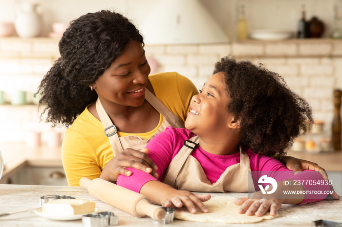 Leisure With Mom. Cute Little Black Girl Baking With Mother In Kitchen