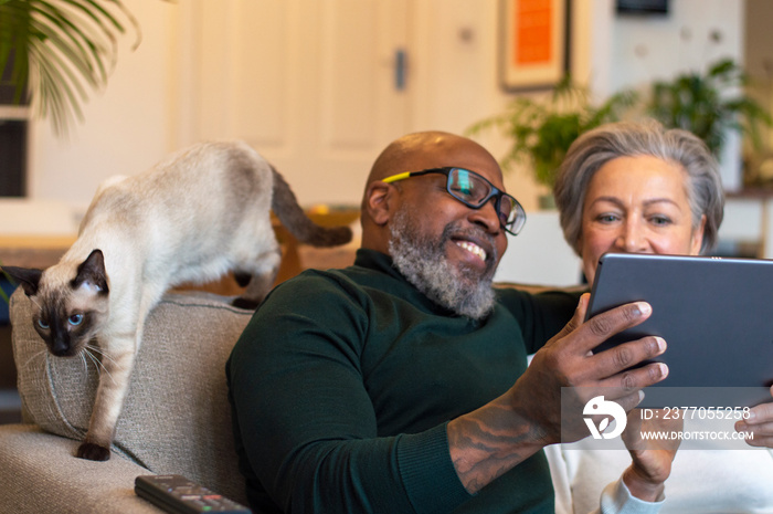 Senior couple using digital tablet at home