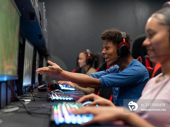 Friends playing video games in gaming club