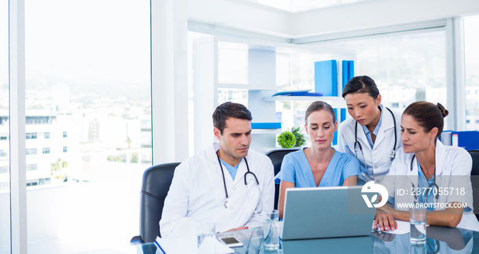 Team of doctors looking at laptop