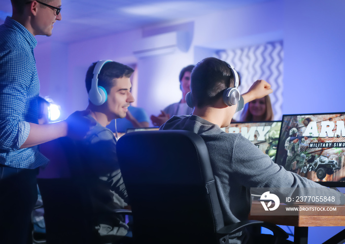 Young people playing video games at tournament