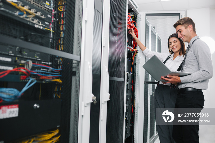 Team of technicians working together on servers at the data centre