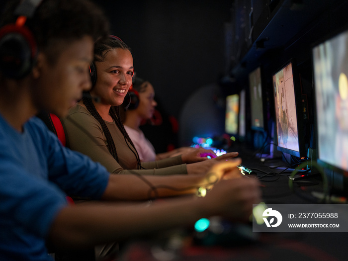 Friends playing video games in gaming club