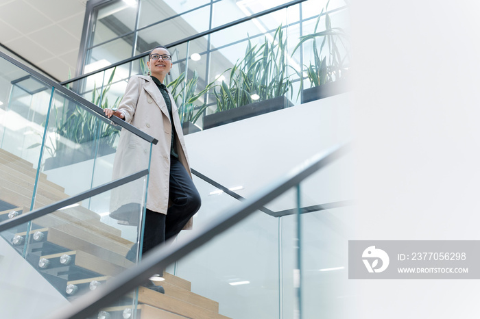 Non binary office worker walking on steps