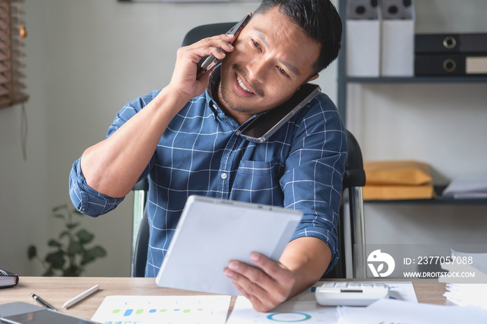 A business man who is using two mobile phones to communicate with customers is difficult. The concept is busy.