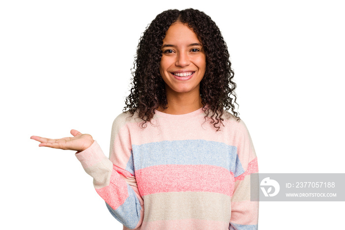 Young Brazilian curly hair cute woman isolated showing a copy space on a palm and holding another hand on waist.